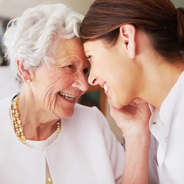Two females smiling at each other